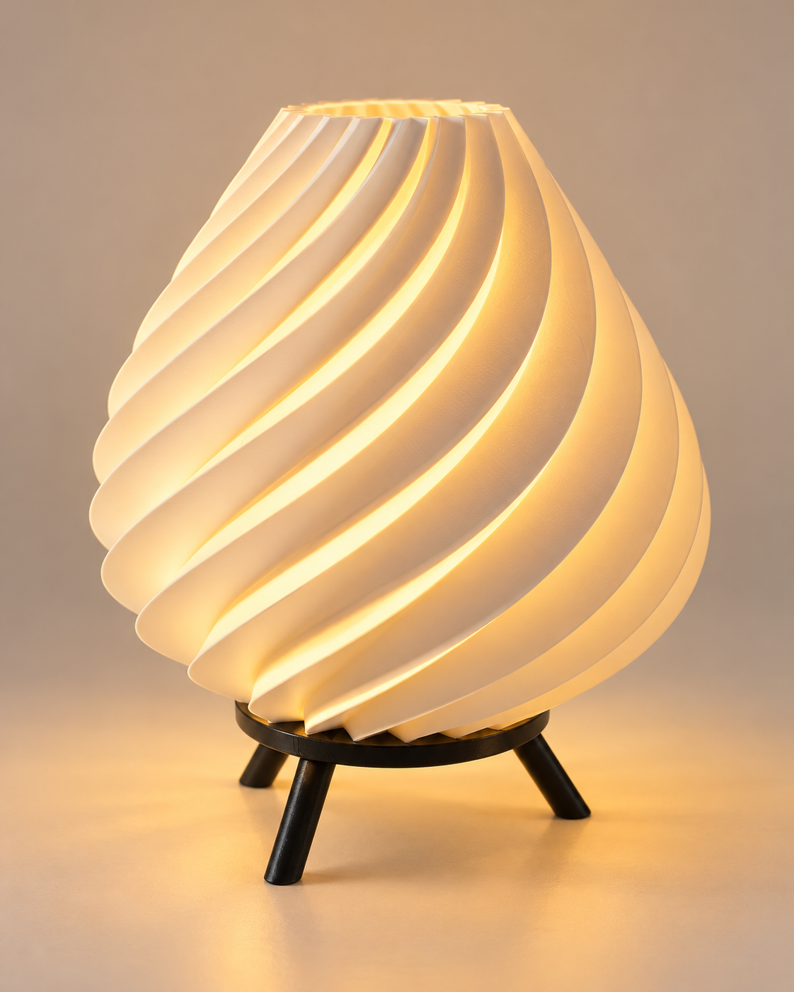 Glowing table lamp with a sculpted spiral helix shade and black tripod-style base.
